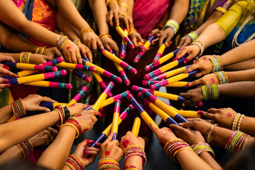 a group of hands holding sticks garba photo नवरात्रि देवी 